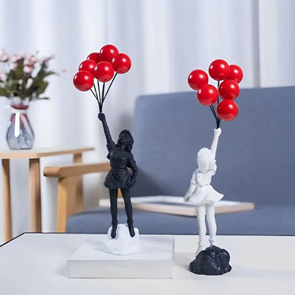 sculpture deux fillette noir blanc ballon rouge table basse