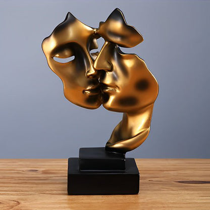 sculpture deux visage or sur table